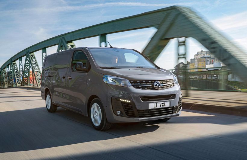 Grey Peugeot Vivaro E front driving over bridge